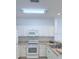 A well-lit kitchen with modern white appliances and ample cabinet space at 3176 Feltrim Pl # 305, Kissimmee, FL 34747