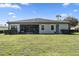 Large backyard with lush lawn and screened patio at 32619 View Haven Ln, Sorrento, FL 32776