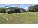 Spacious backyard with large grassy area and home with screened porch at 32619 View Haven Ln, Sorrento, FL 32776
