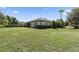 Large backyard with grassy area and home with screened porch at 32619 View Haven Ln, Sorrento, FL 32776