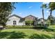 Single-story home with stone accents and lush landscaping at 32619 View Haven Ln, Sorrento, FL 32776