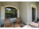 Relaxing front porch with wicker chairs and a side table at 32619 View Haven Ln, Sorrento, FL 32776