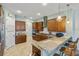 Island kitchen with granite countertops and wooden cabinetry at 32619 View Haven Ln, Sorrento, FL 32776
