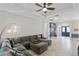 Spacious living room with sectional sofa and floor lamp at 32619 View Haven Ln, Sorrento, FL 32776
