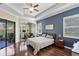 Main bedroom with wood floors, backyard access, and home office at 32619 View Haven Ln, Sorrento, FL 32776