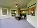 Covered patio with ceiling fan and outdoor furniture, perfect for relaxing and entertaining with sliding glass doors into the home at 32619 View Haven Ln, Sorrento, FL 32776