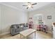 Bright playroom featuring a sofa and toy storage at 32619 View Haven Ln, Sorrento, FL 32776