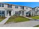 Attractive townhome exteriors with modern design, complemented by well-kept landscaping at 3205 Douglas Fir Dr, Apopka, FL 32703