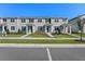 Newly built townhomes with modern exteriors, manicured lawns, and individual entryways at 3205 Douglas Fir Dr, Apopka, FL 32703