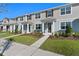 Charming townhouse with manicured lawn, inviting entrance, and well-maintained landscaping at 3221 Douglas Fir Dr, Apopka, FL 32703