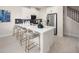Modern kitchen boasts stainless steel appliances, a stylish backsplash, and a spacious white quartz countertop island with seating at 3221 Douglas Fir Dr, Apopka, FL 32703