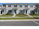 Attractive townhouse exterior featuring gray siding, dark shutters, and landscaped front yard at 3225 Douglas Fir Dr, Apopka, FL 32703