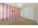 Bedroom with pink striped wall and double doors at 1654 Buckeye Falls Way, Orlando, FL 32824