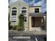 Two-story condo featuring large arched windows, a covered front porch, and designated parking at 2444 Summerfield Way # 1, Kissimmee, FL 34741