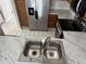 A well-equipped kitchen featuring stainless steel appliances and a double sink at 2444 Summerfield Way # 1, Kissimmee, FL 34741