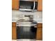The kitchen features stainless steel appliances and wood cabinetry at 2444 Summerfield Way # 1, Kissimmee, FL 34741