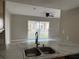 Bright living room with a view to the outside through sliding glass doors at 2444 Summerfield Way # 1, Kissimmee, FL 34741