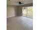 Spacious living room features tiled floors, a ceiling fan, and sliding glass doors to a patio at 2444 Summerfield Way # 1, Kissimmee, FL 34741