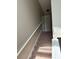 Carpeted staircase with a white handrail leading to the upper level at 2444 Summerfield Way # 1, Kissimmee, FL 34741