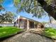 Home's backyard with screened patio and grassy area at 4606 Park Eden Cir, Orlando, FL 32810