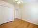 Bright bedroom with wood floors and double doors leading to the hallway at 4606 Park Eden Cir, Orlando, FL 32810