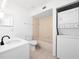 Clean bathroom with a vanity, toilet, tub, and stackable washer and dryer for convenience at 225 Terrace Hill Blvd # 1C, Debary, FL 32713