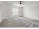 Spacious bedroom featuring a large window for natural light and patterned carpeting at 225 Terrace Hill Blvd # 1C, Debary, FL 32713