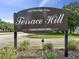 Entrance to Terrace Hill Condominiums at 900 Westridge Drive, with lush landscaping and well-maintained grounds at 225 Terrace Hill Blvd # 1C, Debary, FL 32713