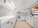 Well-lit kitchen with white cabinetry, sleek countertops, and modern appliances at 225 Terrace Hill Blvd # 1C, Debary, FL 32713
