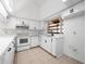 Bright kitchen featuring white cabinetry, modern appliances, and a window offering natural light at 225 Terrace Hill Blvd # 1C, Debary, FL 32713
