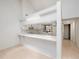 Open kitchen layout with breakfast bar and white cabinetry offering ample storage at 225 Terrace Hill Blvd # 1C, Debary, FL 32713