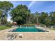 Sparkling community pool surrounded by lush greenery, offering a refreshing outdoor space at 225 Terrace Hill Blvd # 1C, Debary, FL 32713