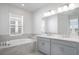 A Primary bathroom featuring a tub and shower combination and a vanity with dual sinks at 4678 Ackee Rd, Kissimmee, FL 34758