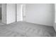 A clean and simple bedroom with neutral colored carpet and trim at 4678 Ackee Rd, Kissimmee, FL 34758