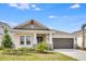 Charming single-story home with a two-car garage and attractive landscaping at 4678 Ackee Rd, Kissimmee, FL 34758