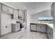 Modern kitchen with stainless steel appliances, gray cabinetry, tile backsplash, and an island with a sink at 4678 Ackee Rd, Kissimmee, FL 34758