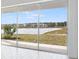 Expansive lake view from the sliding glass doors, creating a serene and picturesque living space at 4678 Ackee Rd, Kissimmee, FL 34758