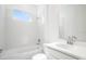 Clean bathroom with a combined tub and shower, vanity and a large mirror at 4672 Ackee Rd, Kissimmee, FL 34758