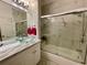 The bathroom features a glass vessel sink, a marble countertop, and a bathtub with glass doors at 122 Crown Point Cir, Longwood, FL 32779