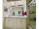 The bathroom features dual glass vessel sinks, a marble countertop, and a shower with glass doors at 122 Crown Point Cir, Longwood, FL 32779