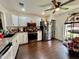 The kitchen features stainless steel appliances, white cabinets, granite countertops, and hardwood floors at 122 Crown Point Cir, Longwood, FL 32779