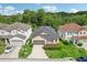 Aerial view of a two-story house with a two-car garage and a well-manicured lawn at 273 Willow View Dr, Davenport, FL 33896