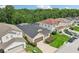 Two-story house with a gray roof, two-car garage, and a screened pool at 273 Willow View Dr, Davenport, FL 33896