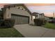 House exterior featuring a double garage and landscaping at 273 Willow View Dr, Davenport, FL 33896