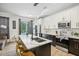 Modern kitchen with a large island and white and black cabinets at 273 Willow View Dr, Davenport, FL 33896