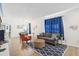 Bright and airy living room with a comfortable couch and geometric patterned rug at 273 Willow View Dr, Davenport, FL 33896