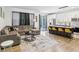 Open living space featuring an L-shaped sectional sofa and a view of the kitchen at 273 Willow View Dr, Davenport, FL 33896