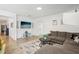 Spacious living room featuring a comfortable sectional sofa and large TV at 273 Willow View Dr, Davenport, FL 33896