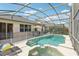 Relaxing pool and spa with screened enclosure and patio furniture at 273 Willow View Dr, Davenport, FL 33896