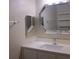 Bathroom featuring a vanity with a white countertop, modern faucet, and decorative mirrors at 911 N Orange Ave # 335, Orlando, FL 32801